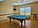 Game room featuring a pool table with a bright blue felt top and wood flooring at 8326 Fantasia Park Way, Riverview, FL 33578