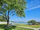 Lakeside view from the community, featuring a grassy area, seating, and a tranquil atmosphere at 8326 Fantasia Park Way, Riverview, FL 33578