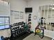 Well-equipped weight room with various dumbbells, medicine balls, and gym rules posted on the wall at 8326 Fantasia Park Way, Riverview, FL 33578