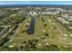 Aerial view of the golf course and condo community with water features and greens at 960 Starkey Rd # 10301, Largo, FL 33771