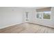 Bright room features wood floors, a window, and a glass patio door at 960 Starkey Rd # 10301, Largo, FL 33771