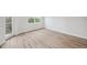 Well-lit room boasts wood floors, a window, and a door with outdoor views at 960 Starkey Rd # 10301, Largo, FL 33771