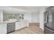 Open-concept kitchen with stainless steel appliances, white cabinets, and views to living area at 960 Starkey Rd # 10301, Largo, FL 33771