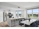 Bright, modern kitchen with stainless steel appliances, island seating, and adjacent dining area with golf course views at 960 Starkey Rd # 10301, Largo, FL 33771