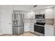 Modern kitchen with stainless steel appliances, white cabinets and light countertops at 960 Starkey Rd # 10301, Largo, FL 33771