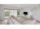 Bright and modern living room featuring hardwood floors, balcony, neutral paint and comfortable couch at 960 Starkey Rd # 10301, Largo, FL 33771