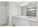 Modern bathroom featuring double vanity with white cabinets, quartz countertop and tiled shower at 1165 Kistna Dr, Zephyrhills, FL 33540