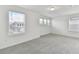 Bright bedroom with neutral carpet and white walls, illuminated by natural light from multiple windows at 1165 Kistna Dr, Zephyrhills, FL 33540