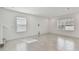 A spacious living room with neutral walls, tile flooring, and large windows for ample natural light at 1165 Kistna Dr, Zephyrhills, FL 33540