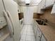 Efficient kitchen featuring white appliances and ample cabinet space at 1235 S Highland Ave # 3-303, Clearwater, FL 33756