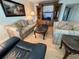 Comfortable living room featuring a classic sofa set and a dark wood entertainment center at 1235 S Highland Ave # 3-303, Clearwater, FL 33756