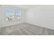 Spacious bedroom featuring large windows, plush carpeting and neutral walls at 1255 Kazaz Ct, Zephyrhills, FL 33540