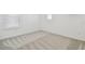 Bedroom with plush carpeting and a window that allows for natural light at 1255 Kazaz Ct, Zephyrhills, FL 33540