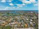 An aerial view showcases the neighborhood, nearby golf course, and nearby waterways at 1370 Brightwaters Ne Blvd, St Petersburg, FL 33704