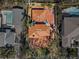 An aerial view of the house featuring a red tile roof, mature landscaping, and a pool at 1370 Brightwaters Ne Blvd, St Petersburg, FL 33704