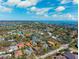 An aerial view showcases the neighborhood, nearby golf course, and nearby waterways at 1370 Brightwaters Ne Blvd, St Petersburg, FL 33704