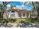 Charming home with a welcoming front porch, a large window, and a well-manicured lawn at 1370 Brightwaters Ne Blvd, St Petersburg, FL 33704