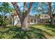 Beautiful home exterior surrounded by mature trees and lush greenery, creating a serene setting at 1370 Brightwaters Ne Blvd, St Petersburg, FL 33704