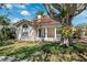 Attractive home with a covered front porch, a charming entrance, and a nicely landscaped yard at 1370 Brightwaters Ne Blvd, St Petersburg, FL 33704