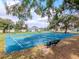 Community basketball court featuring several goals and seating under large shady trees at 25925 Terrawood Loop, Land O Lakes, FL 34639