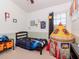 Vibrant bedroom with a playful rocket ship tent and ample natural light from a large window at 25925 Terrawood Loop, Land O Lakes, FL 34639