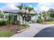 Community clubhouse featuring a welcoming entrance, landscaping, and a light green exterior at 25925 Terrawood Loop, Land O Lakes, FL 34639