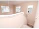 Hallway with windows, a ceiling fan, a staircase with white banister and natural light at 25925 Terrawood Loop, Land O Lakes, FL 34639