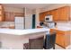 Bright kitchen with wooden cabinets, white countertops, breakfast bar and tile flooring at 25925 Terrawood Loop, Land O Lakes, FL 34639