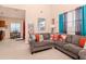 Cozy living room with gray sectional sofa and natural light, open to the dining area at 25925 Terrawood Loop, Land O Lakes, FL 34639