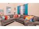 Comfortable living room featuring a plush gray sectional sofa and decorative pillows at 25925 Terrawood Loop, Land O Lakes, FL 34639