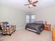 Cozy bedroom with neutral walls, carpet, and a ceiling fan for added comfort at 25925 Terrawood Loop, Land O Lakes, FL 34639