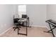 Minimalist office space with neutral walls, a desk setup, and a keyboard instrument at 25925 Terrawood Loop, Land O Lakes, FL 34639