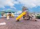 Community playground featuring multiple play structures with slides and a shaded seating area at 25925 Terrawood Loop, Land O Lakes, FL 34639