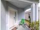 Covered front porch with a chair and table, offering a cozy outdoor seating area and welcoming entrance at 25925 Terrawood Loop, Land O Lakes, FL 34639