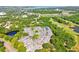 Scenic aerial view of townhomes with a pool, tennis court and pond nearby at 3151 Landmark Dr # 123, Clearwater, FL 33761