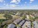 An aerial view of houses with a golf course and driving range in the distance at 3151 Landmark Dr # 123, Clearwater, FL 33761