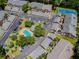 Aerial view of townhomes near the community pool, tennis courts, and parking area at 3151 Landmark Dr # 123, Clearwater, FL 33761