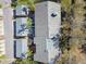 An aerial view showcases the building's layout, surrounded by lush greenery, roofs, and nearby street at 3151 Landmark Dr # 123, Clearwater, FL 33761