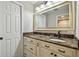 Bathroom featuring a vanity with a marble countertop and a large mirror at 3151 Landmark Dr # 123, Clearwater, FL 33761