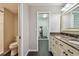 Bathroom featuring dark tile floors, a walk-in shower, and a vanity with marble countertop at 3151 Landmark Dr # 123, Clearwater, FL 33761