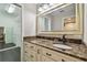 Bathroom vanity featuring a marble countertop and access to a walk-in closet at 3151 Landmark Dr # 123, Clearwater, FL 33761