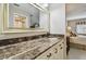 Bathroom vanity featuring a large mirror and marble countertop at 3151 Landmark Dr # 123, Clearwater, FL 33761