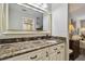 Bathroom vanity featuring a marble countertop and access to a shower at 3151 Landmark Dr # 123, Clearwater, FL 33761