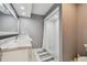 Modern bathroom features a marble countertop, frameless shower, and contemporary finishes at 3151 Landmark Dr # 123, Clearwater, FL 33761