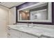 Stylish bathroom boasts a marble countertop, modern fixtures, and large mirror at 3151 Landmark Dr # 123, Clearwater, FL 33761