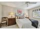 Comfortable bedroom features a ceiling fan and a window for natural light at 3151 Landmark Dr # 123, Clearwater, FL 33761