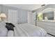 Comfortable bedroom featuring serene color palette, white furnishings, closet, and open doorway at 3151 Landmark Dr # 123, Clearwater, FL 33761