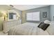 Comfortable bedroom featuring serene color palette, white furnishings, and a large window at 3151 Landmark Dr # 123, Clearwater, FL 33761