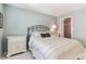 Comfortable bedroom featuring serene color palette, nightstand, closet, and decorative headboard at 3151 Landmark Dr # 123, Clearwater, FL 33761