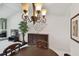 Cozy dining room with chandelier, dark wood floors, and seating for four at 3151 Landmark Dr # 123, Clearwater, FL 33761